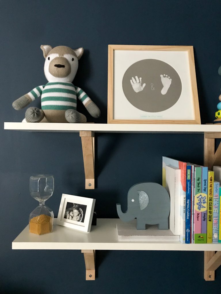 dark blue nursery, navy blue nursery, moody nursery, animal print, safari theme nursery, tribal nursery, lion rocker, tarva dresser, Ikea dresser hack, white crib, tiger print, elephant print, lion print, tribal rug, nursery books  