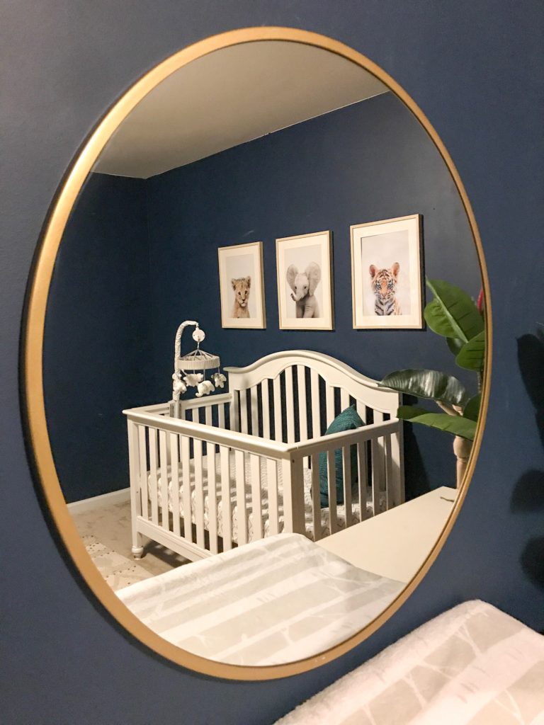 dark blue nursery, navy blue nursery, moody nursery, animal print, safari theme nursery, tribal nursery, lion rocker, tarva dresser, Ikea dresser hack, white crib, tiger print, elephant print, lion print, tribal rug, nursery books  