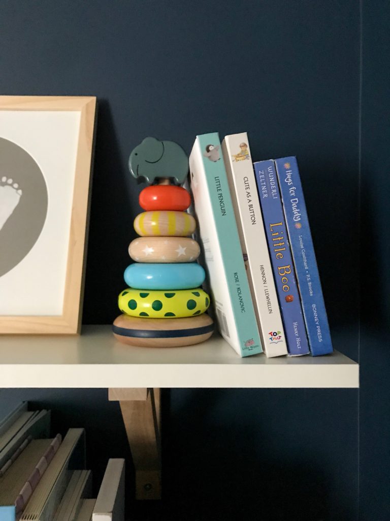 dark blue nursery, navy blue nursery, moody nursery, animal print, safari theme nursery, tribal nursery, lion rocker, tarva dresser, Ikea dresser hack, white crib, tiger print, elephant print, lion print, tribal rug, nursery books  