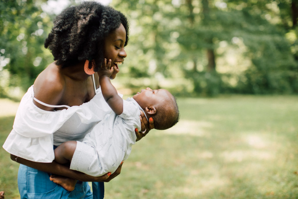 mother and son, blue shorts, statement earrings, natural hair 