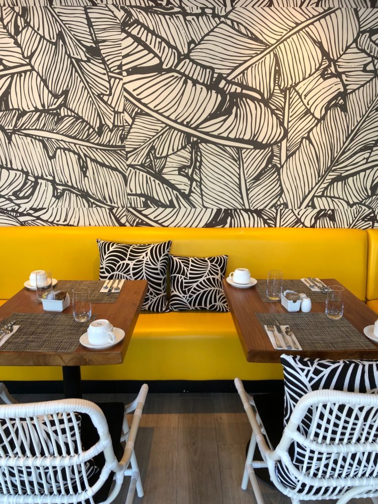 breakfast nook, dining in, yellow seats, wood table, decor, travel decor