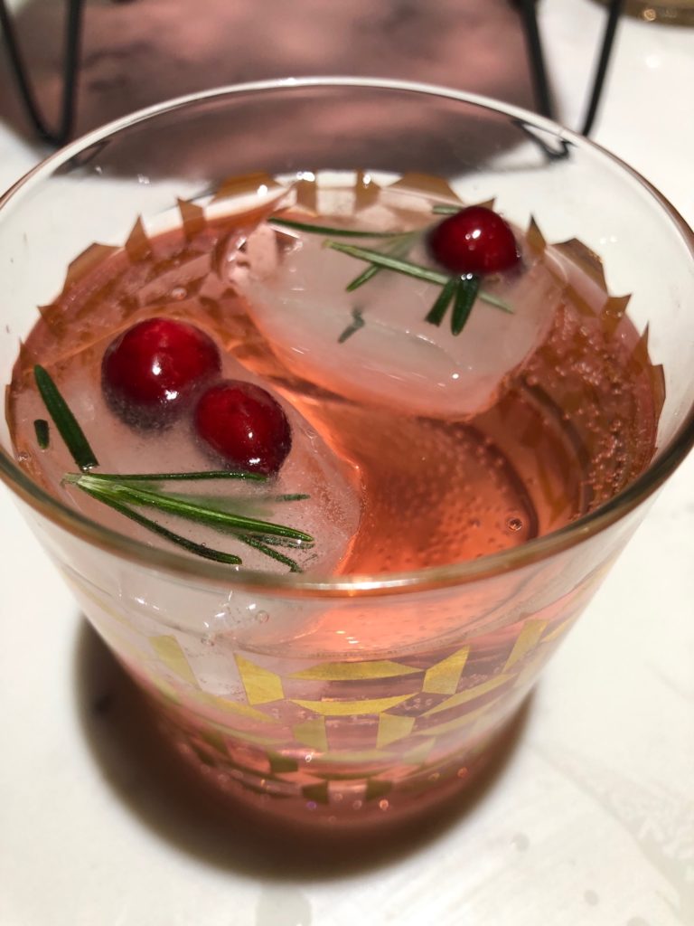 festive cocktails, fruit in ice cubes, gold cocktail glasses