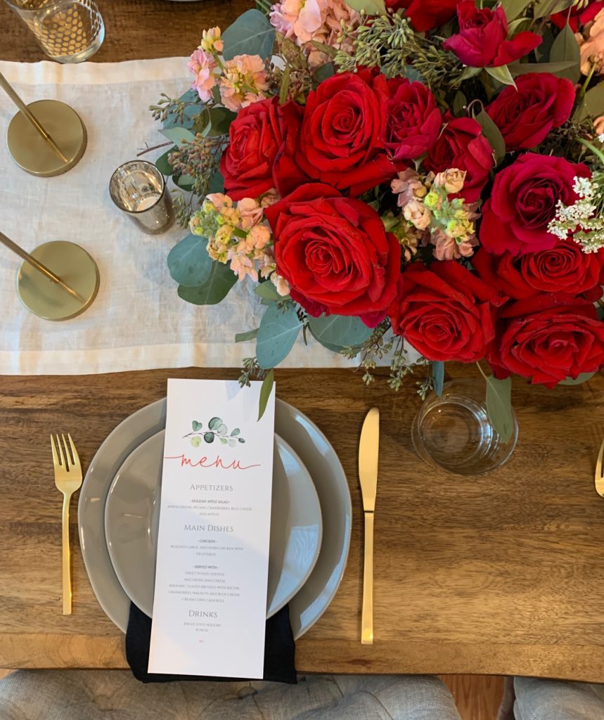 floral arrangement, holiday dinner, festive, cocktail, gold accents, tapered candles, floral bouquet, gold flatware