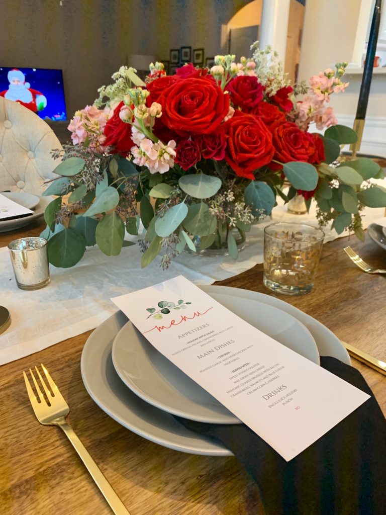 floral arrangement, holiday dinner, festive, cocktail, gold accents, tapered candles, floral bouquet, gold flatware