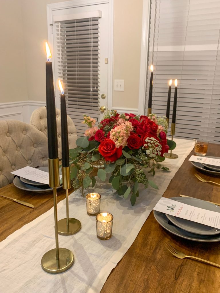 floral arrangement, holiday dinner, festive, cocktail, gold accents, tapered candles, floral bouquet, gold flatware