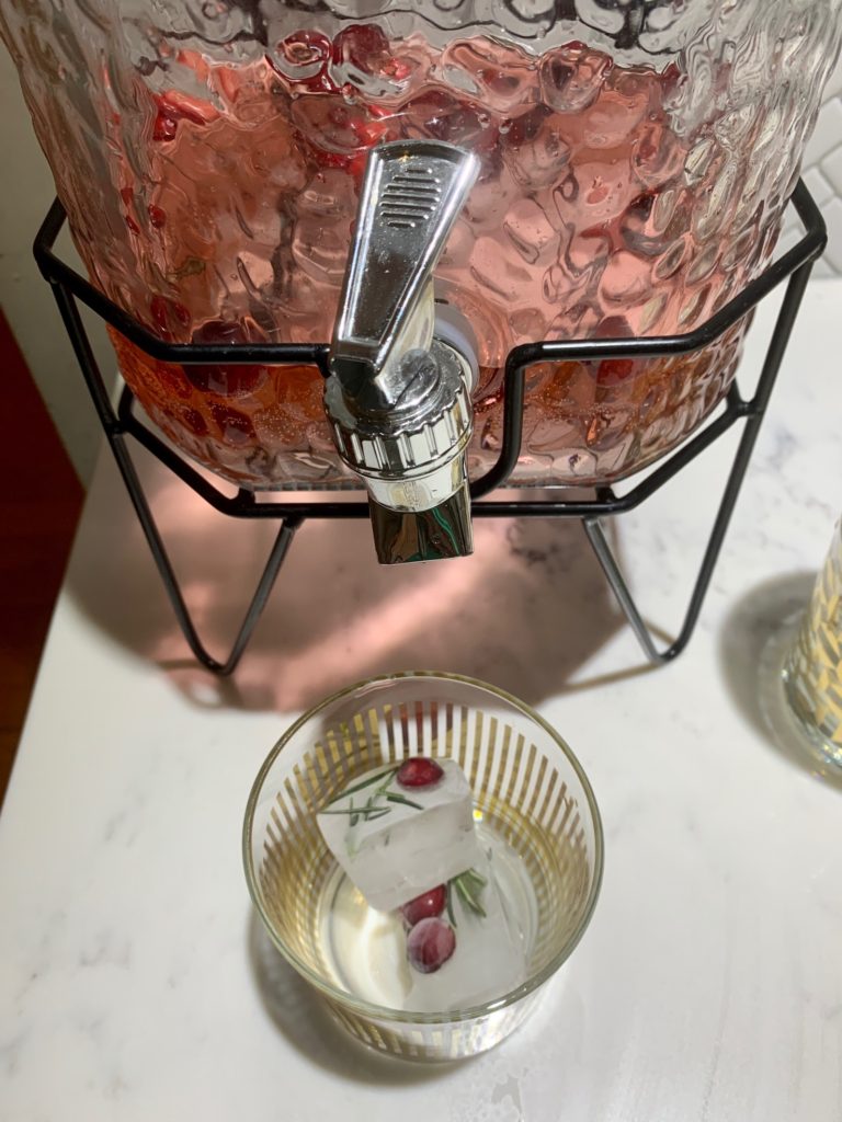 festive cocktails, fruit in ice cubes, gold cocktail glasses